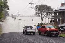  ?? BIANCA DE MARCHI/AAP ?? Residentia­l properties and roads are submerged under floodwater from the Hawkesbury River in Windsor, north of Sydney, Australia.