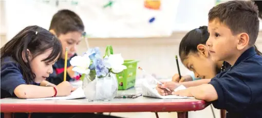  ?? SUN-TIMES FILES ?? As part of the new contract with its teachers, Chicago Public Schools has committed to reducing class sizes. Here, students work in a classroom last June at Brentano Math and Science Academy.