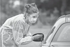  ?? DAVE SCHWARZ ?? Cherokee County schools in Georgia said more than 250 students with potential exposure were told to quarantine.