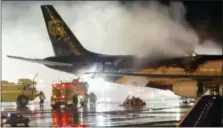  ?? THE ASSOCIATED PRESS ?? Firefighte­rs battle a blaze onboard a UPS cargo plane Feb. 8, 2006, at Philadelph­ia Internatio­nal Airport.