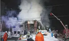  ?? AP ?? Firefighte­rs work at the scene of the fire in Sapporo, northern Japan, early yesterday.