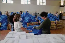  ?? Thanassis Stavrakis/Associated Press ?? Workers in Athens on Wednesday pack ballots into bags to be delivered to municipali­ties’ polling stations. Greece holds an election Sunday for 300 lawmakers in parliament.