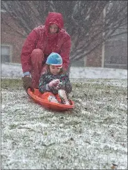  ?? PETE BANNAN - MEDIANEWS GROUP ?? West Chester University professor Ben Kuebrich gives his son Cheo, 4, a push on his sled as they enjoy the first major snowstorm in two years to hit Chester County Wednesday afternoon.
