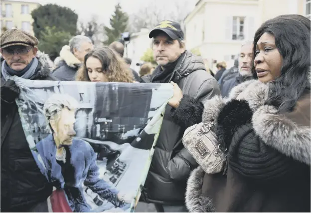  ?? PICTURE: ERIC FEFERBERG/AFP/GETTY IMAGES ?? 0 Fans gathered outside the Paris home of French rock star Johnny Hallyday as news of the musical icon’s death spread