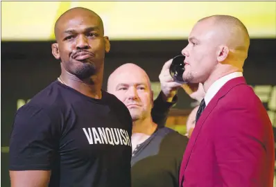  ?? PHOTOS BY STEVE MARCUS ?? UFC light heavyweigh­t champion Jon Jones, left, looks uninspired as he poses with his next challenger, Anthony Smith, during a Jan. 31 news conference for UFC 235 at MGM Grand. UFC 235 will take place March 2 at T-mobile Arena.