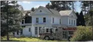  ?? NICHOLAS BUONANNO — NBUONANNO@ TROYRECORD. COM ?? Firefighte­rs cut open a hole in the roof of 97Glenwood Road in North Greenbush after a fire there Thursday morning.