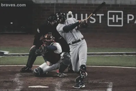  ?? JOHN BAZEMORE/AP ?? HOUSTON ASTROS’ CARLOS CORREA HITS AN RBI-DOUBLE Houston Astros and the Atlanta Braves Sunday in Atlanta. during the third inning in Game 5 of the World Series between the