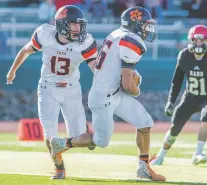  ?? SHEILA MILLER/TAOS NEWS ?? Taos quarterbac­k Justin Good hands off to Jonathan Garcia on Nov. 24 against Portales in the state semifinal. The Tigers take on Bloomfield on Saturday for the state title.
