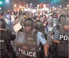  ?? SCOTT OLSON, GETTY IMAGES ?? Police are deployed in St. Louis on Saturday night as demonstrat­ors protest the acquittal of former St. Louis police officer Jason Stockley.