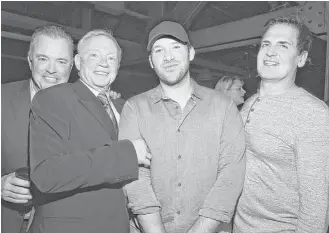  ?? Mike Coppola / Getty Images for DirecTV ?? It appears in this 2016 photo that Cowboys owner Jerry Jones doesn’t want to let go of Tony Romo, but the QB retired. So Mark Cuban, right, found a place for Romo on the Mavs’ bench for a night.