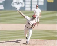  ?? NWA Democrat-Gazette/Charlie Kaijo ?? Arkansas Kevin Kopps (45) throws a pitch during the ninth inning of an April 3 game at Baum-Walker Stadium in Fayettevil­le. Kopps held on late to win for the Razorbacks Sunday in Oxford, Miss.