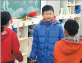  ?? JI WANG AND LUO HAO / FOR CHINA DAILY ?? Xiaolei (center) with his classmates at Jilin Orphan School in Changchun, Jilin province.