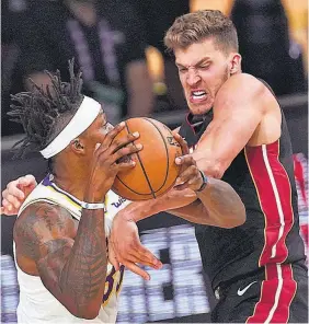  ??  ?? No se rinden. Meyers Leonard, del Heat, pelea por el balón con Dwight Howard.