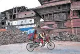  ?? BERNAT ARMANGUE / AP ?? A Nepali cycle rickshaw pedals past buildings at Basantapur Durbar Square that were damaged in a 2015 earthquake in Kathmandu, Nepal.