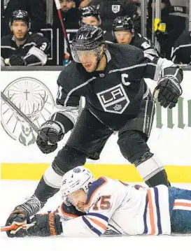  ?? MARK J. TERRILL AP ?? Edmonton right wing Josh Archibald (15) dives for the puck while under pressure from Kings center Anze Kopitar in Thursday night’s Game 6, won by the Oilers.