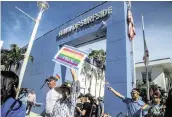  ?? PEDRO PORTAL pportal@miamiheral­d.com ?? Residents protest on June 28 at Town Hall against Surfside’s decision not to fly the LGBTQ flag for Pride month. The commission is deadlocked on flying the flag next year.