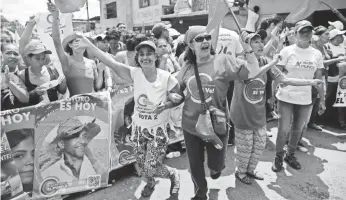  ?? ARIANA CUBILLOS, AP ?? People cheer during a pro-government candidates rally in Caracas, Venezuela, on Tuesday.