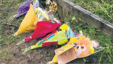  ??  ?? Tributes left at the crash site where motorcycli­st Adam Coates died