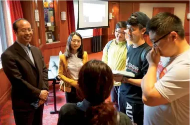  ?? PROVIDED TO CHINA DAIY ?? Above: Consul Wang Wenhua (left) and Consul Wu Yimeng (second from left) talk with Chinese students at Ohio State University in Columbus, Ohio on Wednesday.