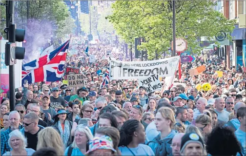  ??  ?? Thousands of anti-lockdown protesters march in Oxford Street, London, yesterday in opposition to the Covid passports that are being considered by ministers