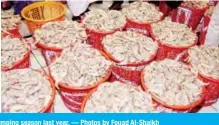  ??  ?? KUWAIT: These August 1, 2018 file photos show heavy turnout of buyers at the Sharq fish market on the first day of the start of the shrimping season last year. — Photos by Fouad Al-Shaikh