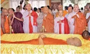  ??  ?? A group of Buddhist monks from several Asian countries paid their last respects to Ven. Maduluwawe Sobhitha Thera yesterday at Kotte Sri Naga Vihara. Pic by Kushan Pathiraja.