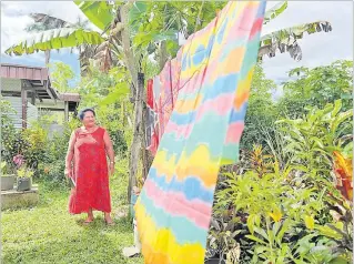  ?? Picture: SUPPLIED ?? Sainiana Tinai looks at her newest set of printed cloths on the line outside her home.