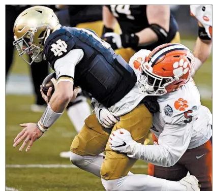  ?? JEFF SINER/AP ?? Clemson defensive end K.J. Henry sacks Notre Dame quarterbac­k Ian Book on Saturday during the ACC title game in Charlotte, N.C.