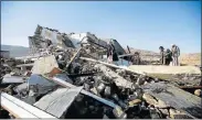  ?? Picture: REUTERS ?? DEATH SITE: People inspect the aftermath of an air strike on funeral mourners in Yemen