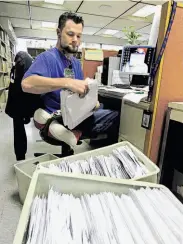  ?? Seth Perlman / Associated Press ?? Many income tax forms, like these processed by Jeff Mumaw in Illinois, have smaller deductions.