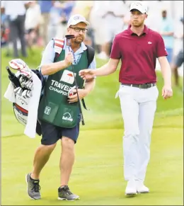  ?? Peter Hvizdak / Hearst Connecticu­t Media ?? Caddie Grant Berry, left, with Daniel Berger during the second round of the Travelers Championsh­ip on Friday at TPC River Highlands in Cromwell.