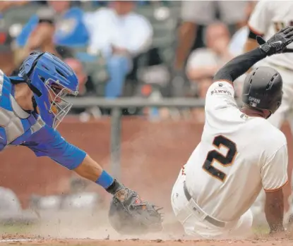  ??  ?? Giants baserunner Denard Span slides past Cubs catcher Alex Avila to score in the seventh inning Wednesday. | GETTY IMAGES