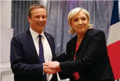  ?? —AFP ?? PARIS: Former French presidenti­al election candidate for the right-wing Debout la France (DLF) party Nicolas Dupont-Aignan (left) and French presidenti­al election candidate for the far-right Front National (FN) party Marine Le Pen, shake hands at the...