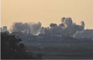  ?? (Alexi J. Rosenfeld/Getty Images/TNS) ?? SMOKE RISES from buildings in northern Gaza this week after IAF attacks.