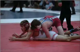  ?? PAUL DICICCO — FOR THE NEWS-HERALD ?? A Mentor wrestler grapples with an opponent March 7 in the Division I district tournament.