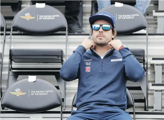  ?? — THE ASSOCIATED PRESS ?? Fernando Alonso waits for the start of the drivers’ meeting in advance of the Indianapol­is 500. The 101st running of the race is Sunday at Indianapol­is Motor Speedway, which will be the Formula One veteran’s first race on a oval track.