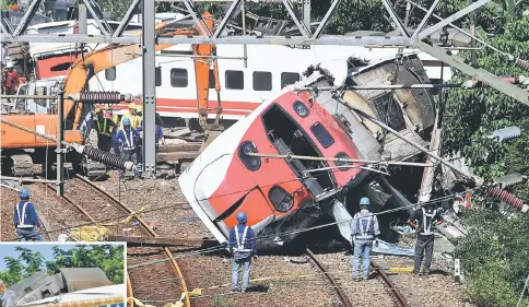  ??  ?? Rescue workers work at the site where the train derailed in Yilan county,Taiwan. — Reuters photo