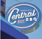  ?? TOM BAILEY ?? The new Central BBQ signs play off the colors inside the restaurant as well as Tiger blue of the University of Memphis.