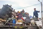  ?? FATIMA SHBAIR/ASSOCIATED PRESS ?? Palestinia­ns arrive in the southern Gaza town of Rafah after fleeing an Israeli ground and air offensive in the nearby city of Khan Younis on Friday.