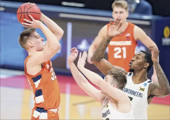  ?? Darron Cummings / Associated Press ?? Syracuse's Buddy Boeheim, who scored 22 of his 25 points in the second half, shoots over defenders in the NCAA Tournament on Sunday.