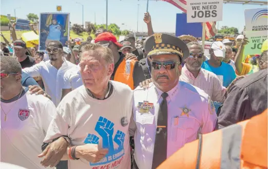  ?? ASHLEE REZIN/ SUN- TIMES PHOTOS ?? ABOVE: The Rev. Michael Pfleger and Chicago Police Supt. Eddie Johnson march alongside thousands of anti- violence protesters on the Dan Ryan Expressway on Saturday. LEFT: Protesters march in the inbound lanes of the Dan Ryan.