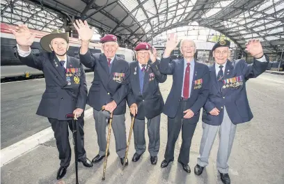  ??  ?? Joe Mawdsley, centre with fellow veterans, from left: Phil Hayden, Joe McAllister, Eric Dickinson and John Dennett at Lime Street Station before heading off to a Royal Garden Party in 2014