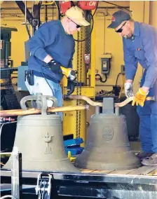  ??  ?? HOMEWARD BOUND – Workers prepare to place two of three Balangiga bells in a wooden crate at F.E. Warren Air Force Base in Wyoming, USA, for its return flight to the Philippine­s. The bells are scheduled to arrive here on Tuesday, Dec. 11. (Photo courtesy of the US Embassy)