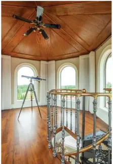  ??  ?? Continuous cherry hardwoods anchor the tower room/observator­y that features a brass and cast iron circular staircase that was reclaimed from an 18th-century Parisian hotel. An oak roof overlooks 360-degree views from its lofted third floor height.