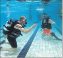  ?? Arthur Stone) ?? Blackwater SAC diver George Goggin with trainee Aaron, going through their scuba skills. (Pic: