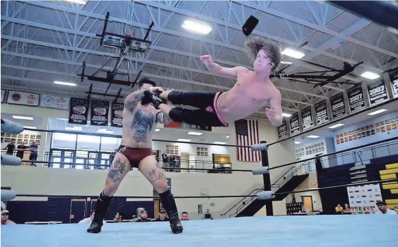  ??  ?? DeSoto County wrestler Noah Nelms, who goes by the name Marko Stunt, delivers a dropkick during match. DWYNDL NELMS / FOR THE COMMERCIAL APPEAL