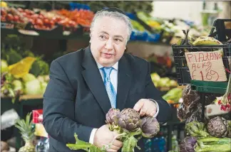  ??  ?? Rabbi Umberto Piperno prepares to buy some artichokes at a market in Rome, in disagreeme­nt with the Israeli decree.