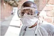  ??  ?? A health worker wears protective clothing outside an isolation ward to diagnose and treat suspected Ebola patients, at Bikoro Hospital in Bikoro, the rural area where the Ebola outbreak was announced last week, in Congo