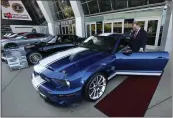  ?? RICH PEDRONCELL­I — THE ASSOCIATED PRESS FILE ?? McGregor Scott, the U.S. Attorney for the Eastern District of California, looks over a 2007 Ford Shelby GT500 displayed in Sacramento that was among the vehicles seized by the federal government to be auctioned off.