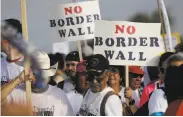  ?? Eric Gay / Associated Press ?? Hundreds of protesters march along a levee toward the Rio Grande to oppose the proposed border wall.